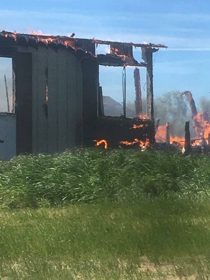 black building in field on fire