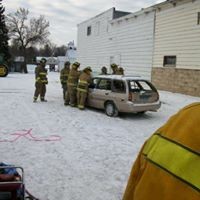 Firefighters surrounding a car for training